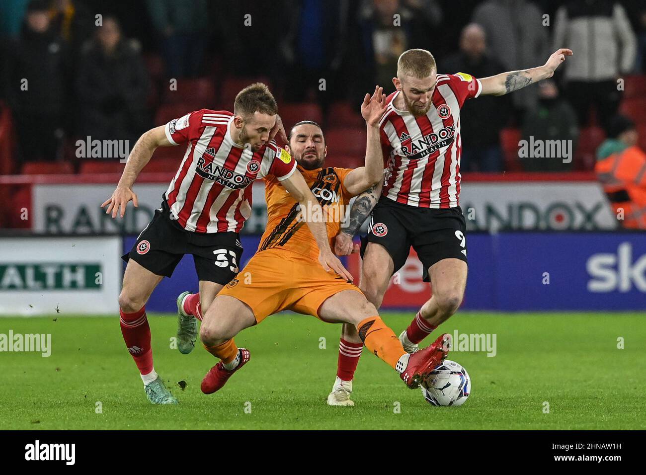 Lewis Coyle #2 of Hull City is tackled by Rhys Norrington-Davies #33 of Sheffield United and Oliver McBurnie #9 of Sheffield United Stock Photo