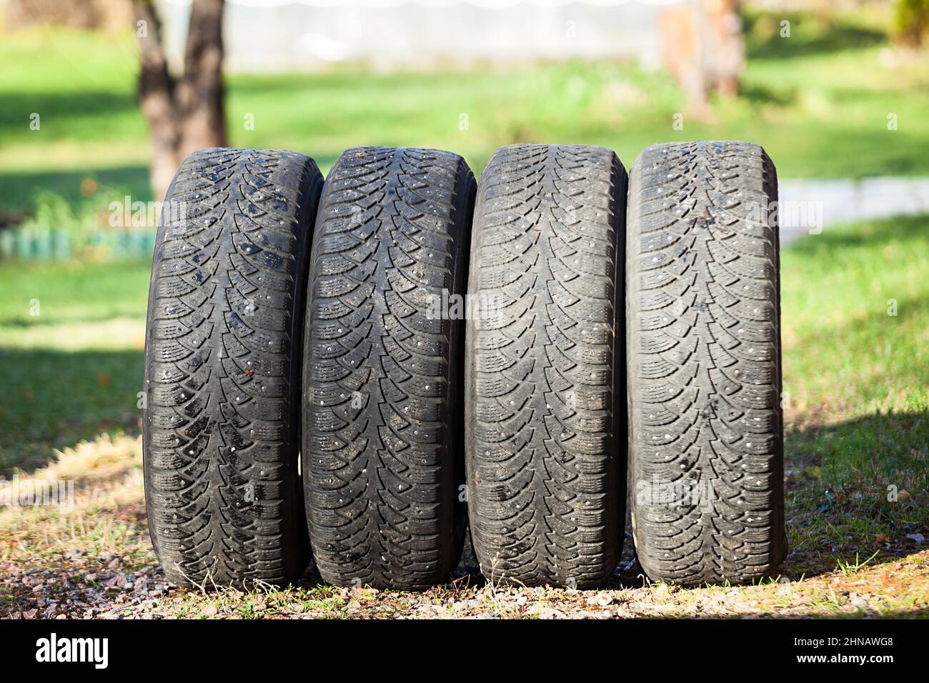 Set of used winter tires removed from car after cold season, the spring Stock Photo