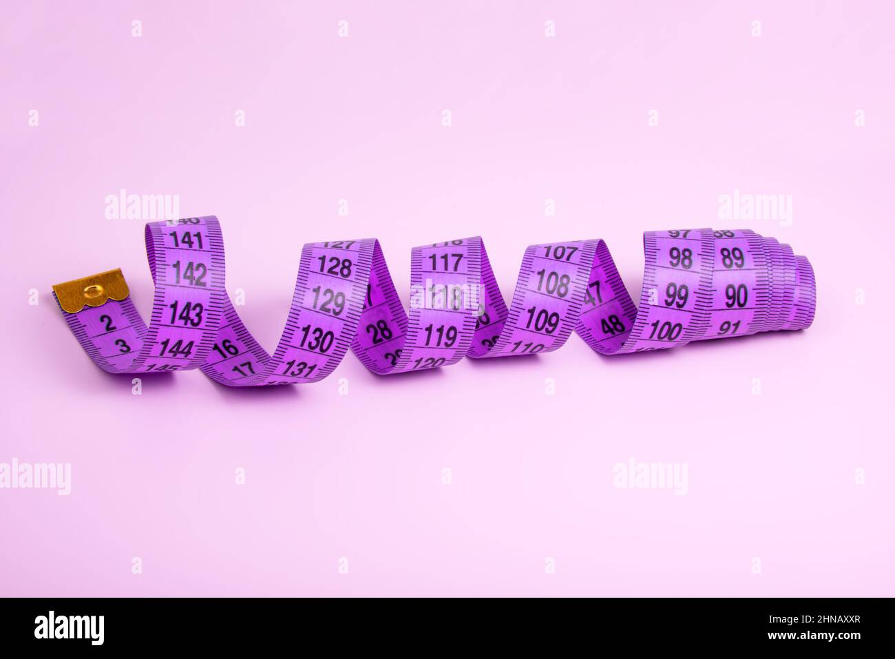 https://c8.alamy.com/comp/2HNAXXR/bright-purple-tape-measure-on-violet-background-with-copyspace-2HNAXXR.jpg