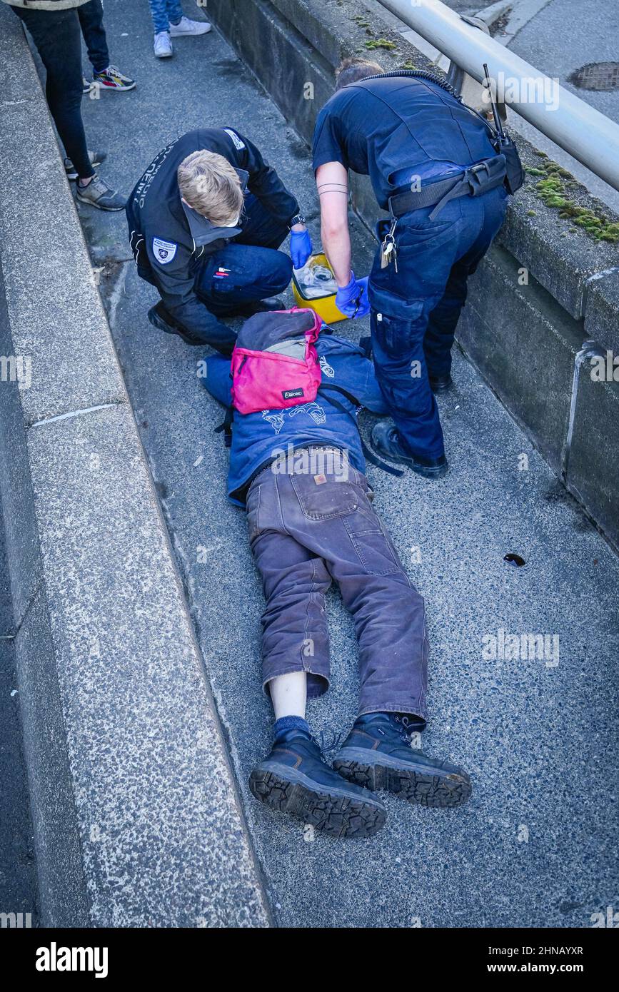 Paramedics attend to man injured in e-scooter accident, Vancouver, British Columbia, Canada Stock Photo