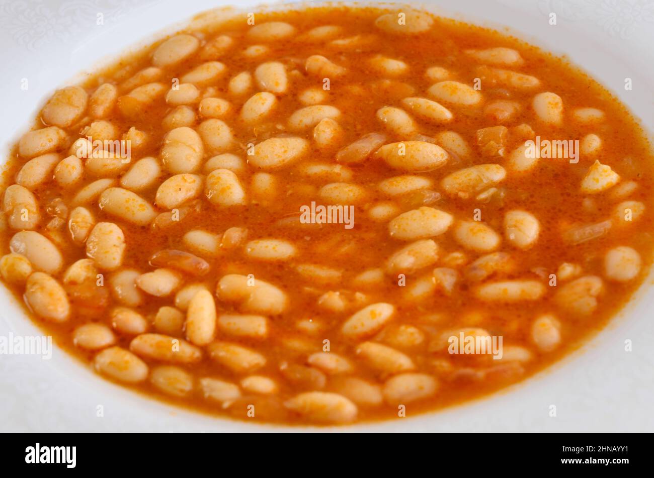 Closeup of Haricot Bean. Popular Turkish food: Kuru Fasulye on white plate background. Popular traditional food of Turkey and Middle East. Stock Photo