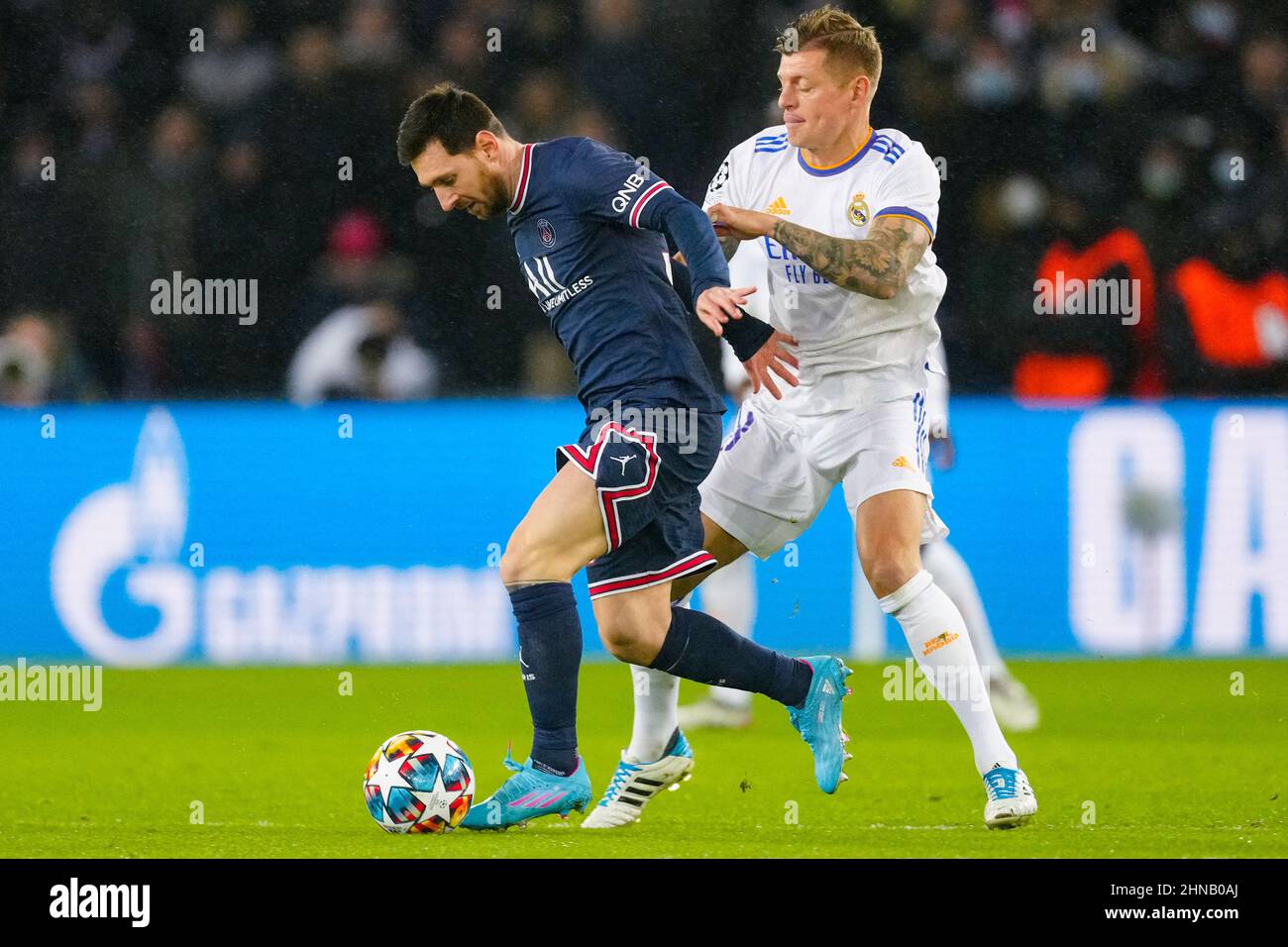 PARIS, FRANCE - FEBRUARY 15: Lionel Messi of Paris Saint-Germain runs with the ball Toni Kroos of Real Madrid prior to the Round Of Sixteen Leg One - UEFA Champions League match between Paris Saint-Germain and Real Madrid at Stade de France on February 15, 2022 in Paris, France (Photo by Geert van Erven/Orange Pictures) Stock Photo
