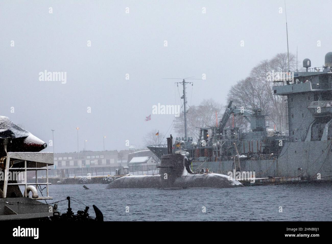 German navy replenishment and support vessel Main A515 in port of Bergen, Norway. Alongside is German submarine U32 (S182).  A foggy winter day Stock Photo