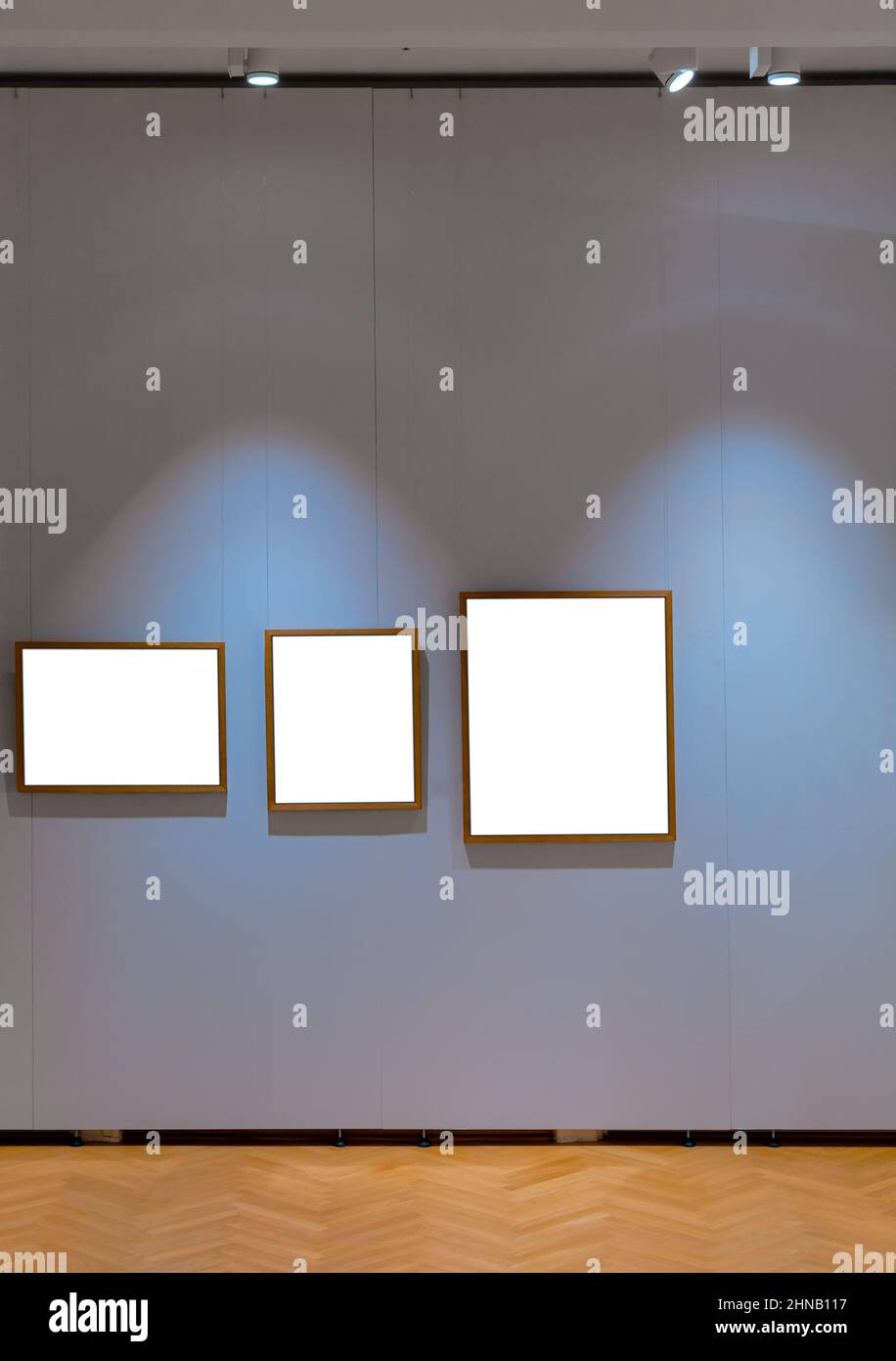 Three old wooden frame in a galery hanging on the wall Stock Photo - Alamy