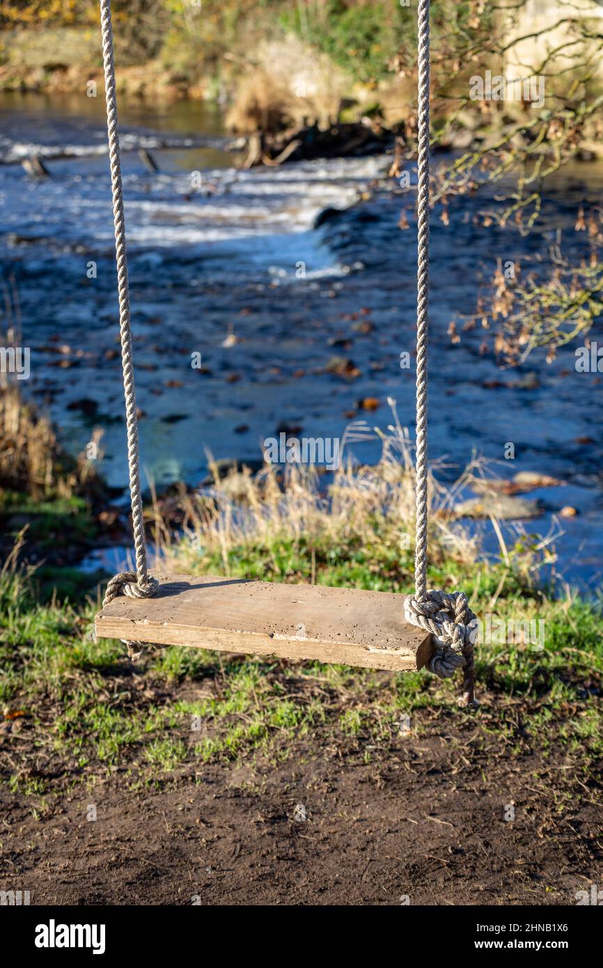 A swing seat hanging at the side of the River Goyt, Chadkirk, Stockport, Greater manchester, England, UK Stock Photo