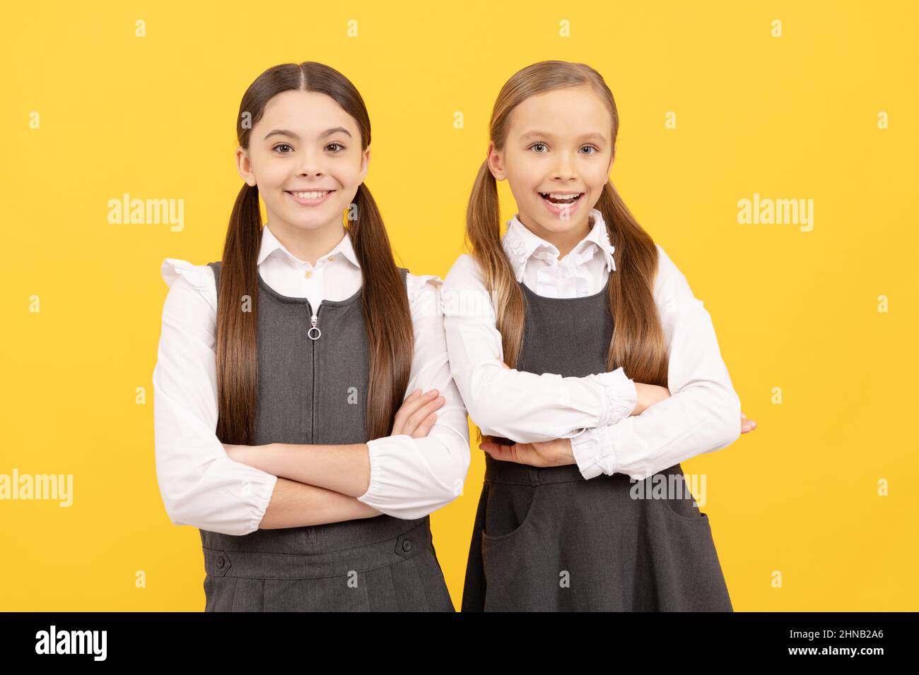 Educating the little minds. School children yellow background. Back to school. Childhood education Stock Photo