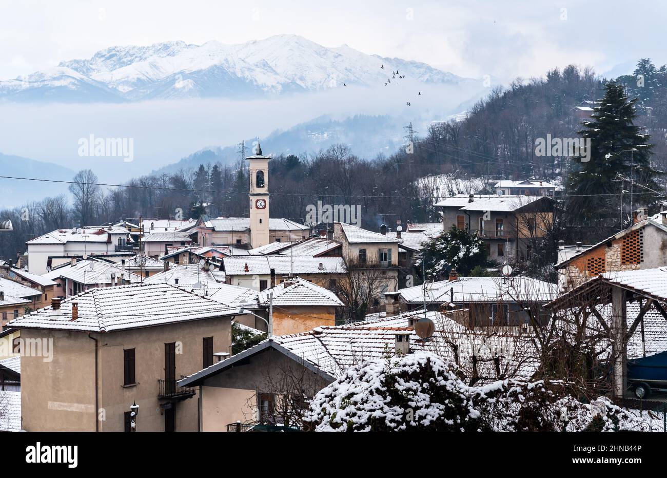 Top view of the small village Ferrera di Varese covered by snow in a winter day, province of Varese, Lombardy, Italy Stock Photo