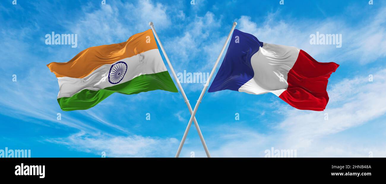 crossed national flags of India and France flag waving in the wind at ...