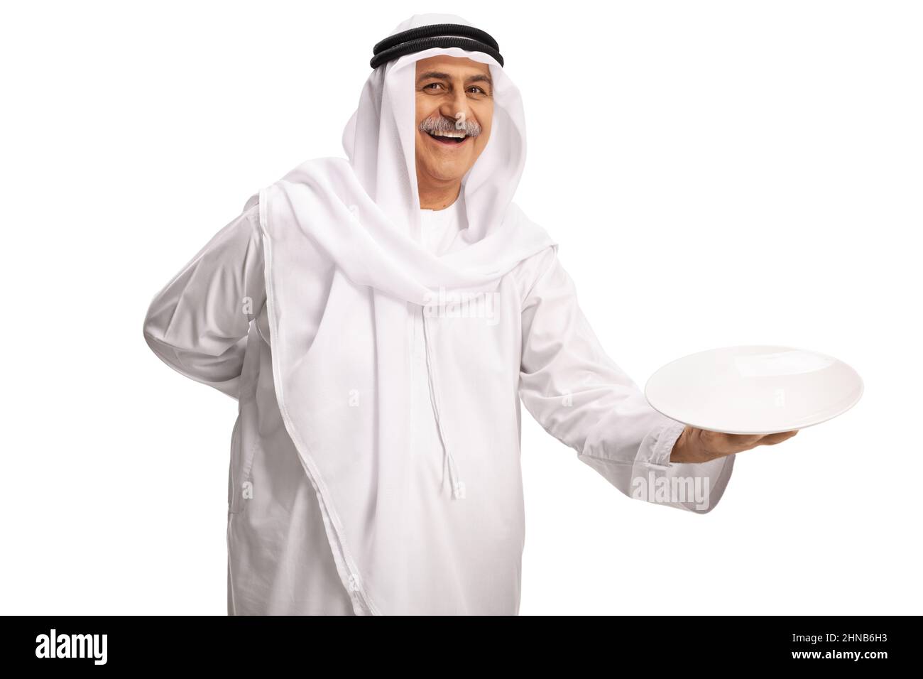Mature arab man holding an empty plate and smiling isolated on white background Stock Photo