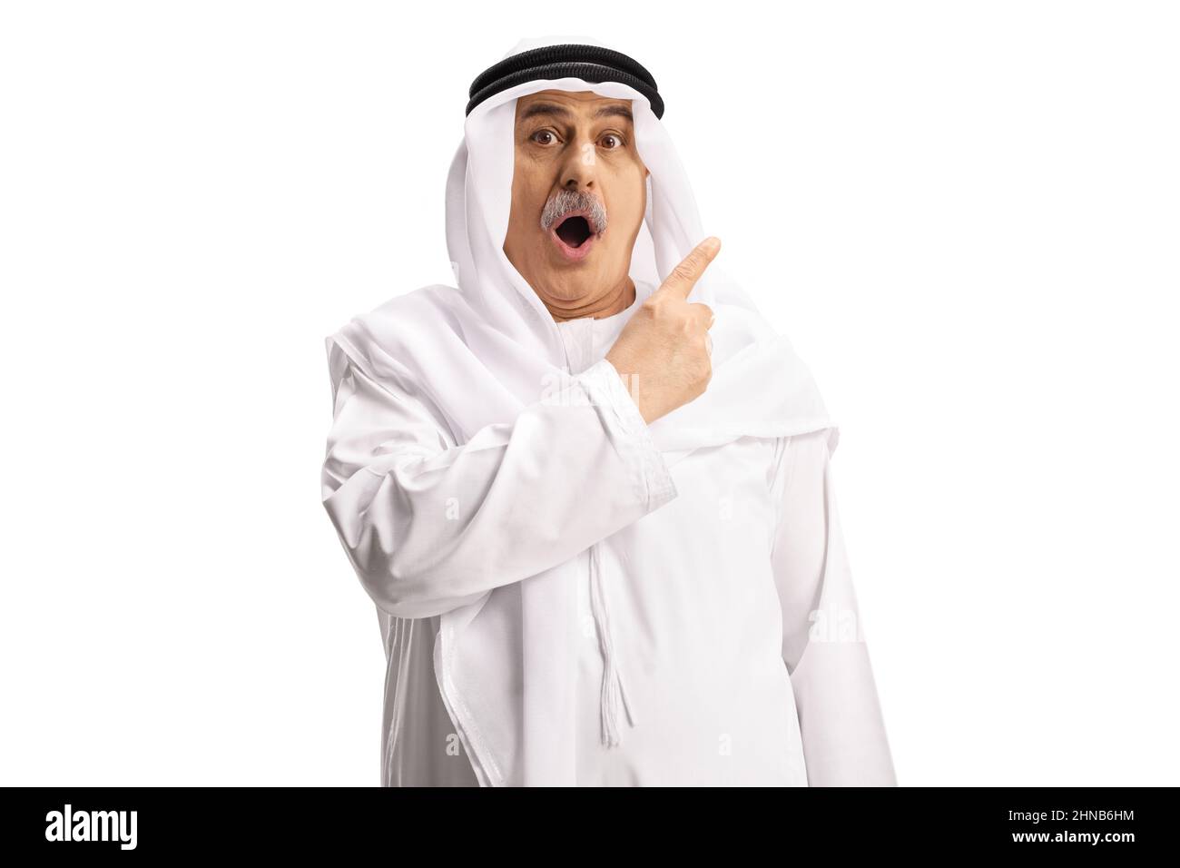 Surprised mature arab man pointing with finger isolated on white background Stock Photo