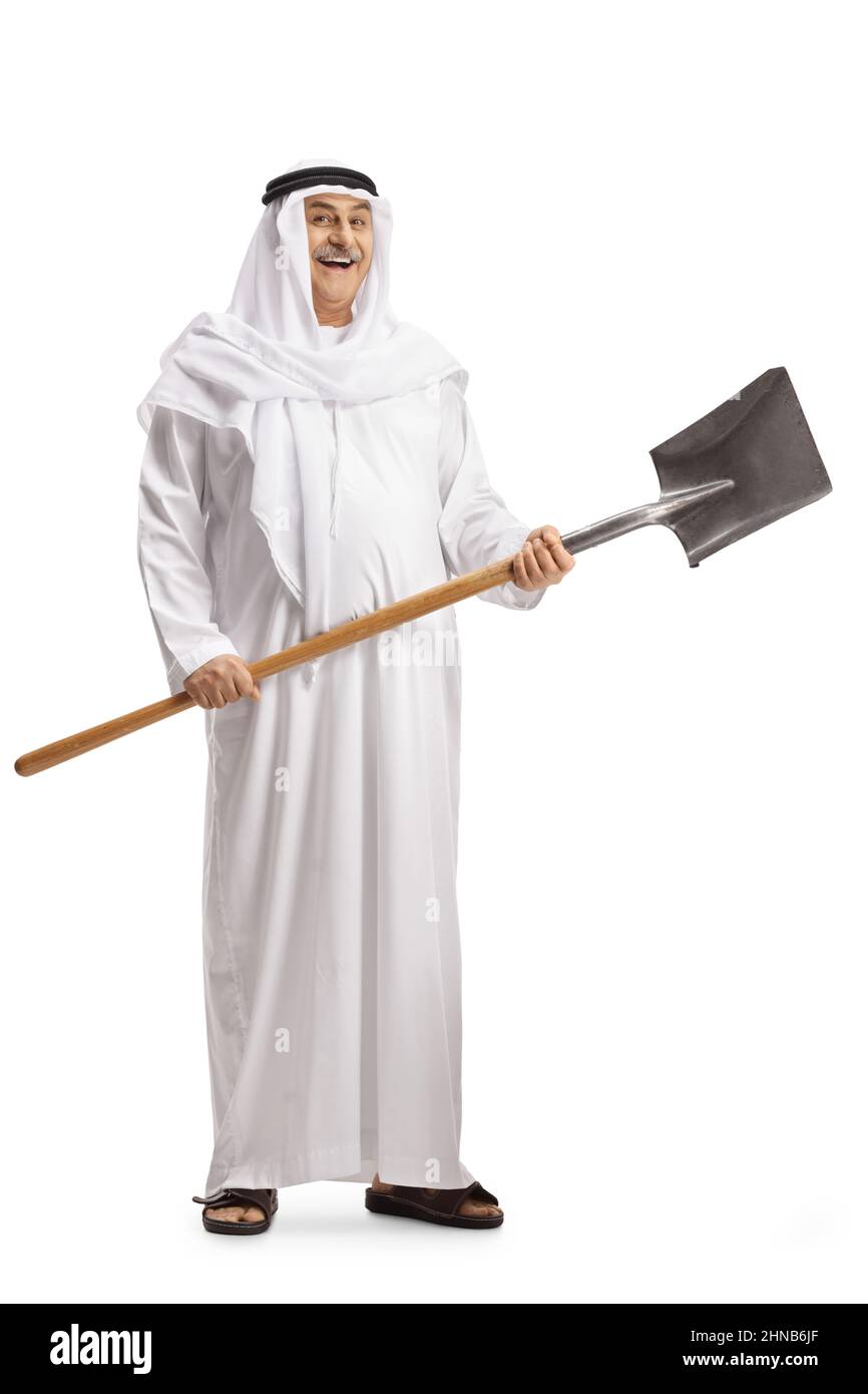 Full length portrait of a mature arab man smiling and holding a shovel isolated on white background Stock Photo