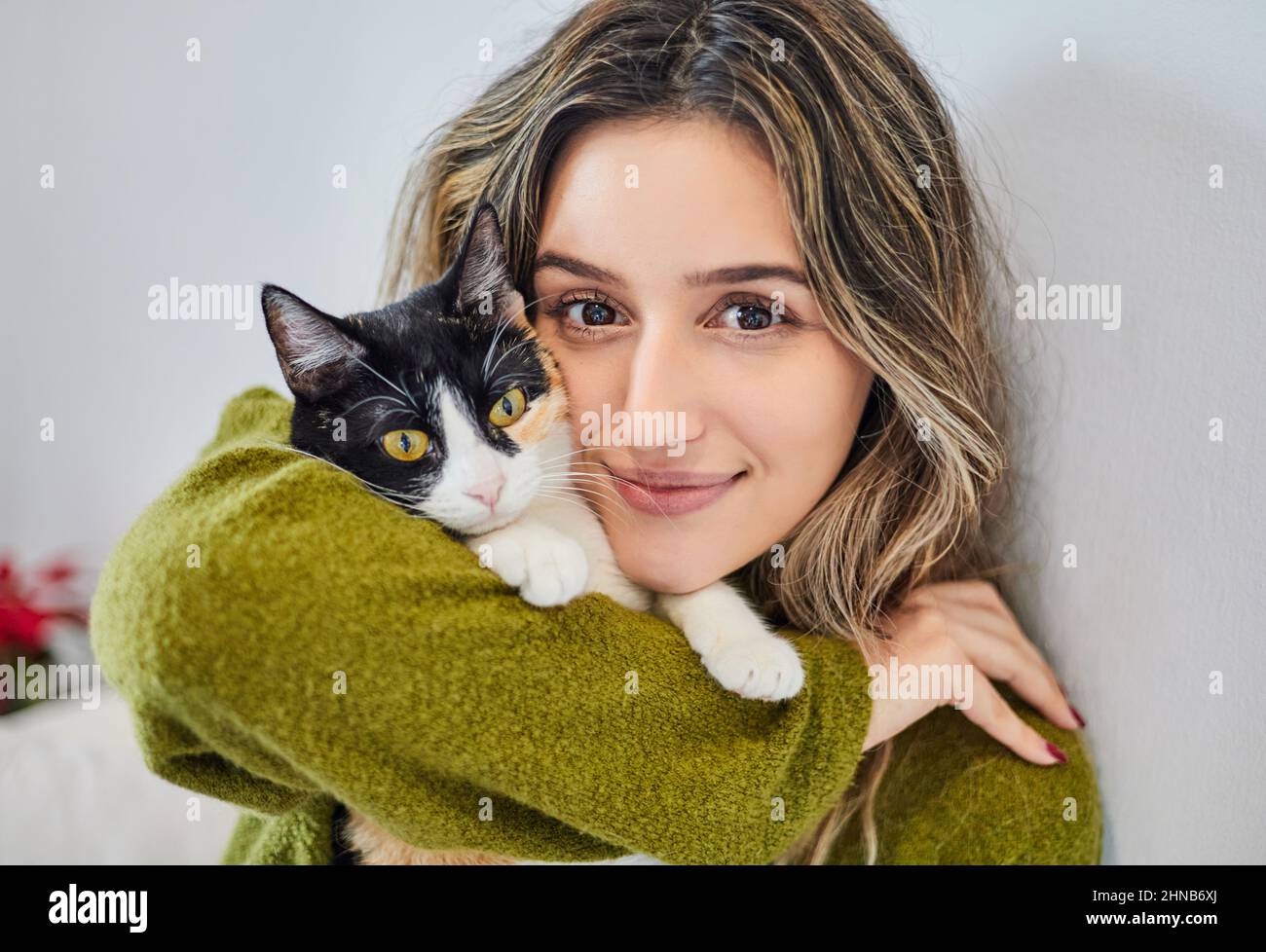 Close up of a beautiful girl hugging her cat. Love for her feline pet. Stock Photo