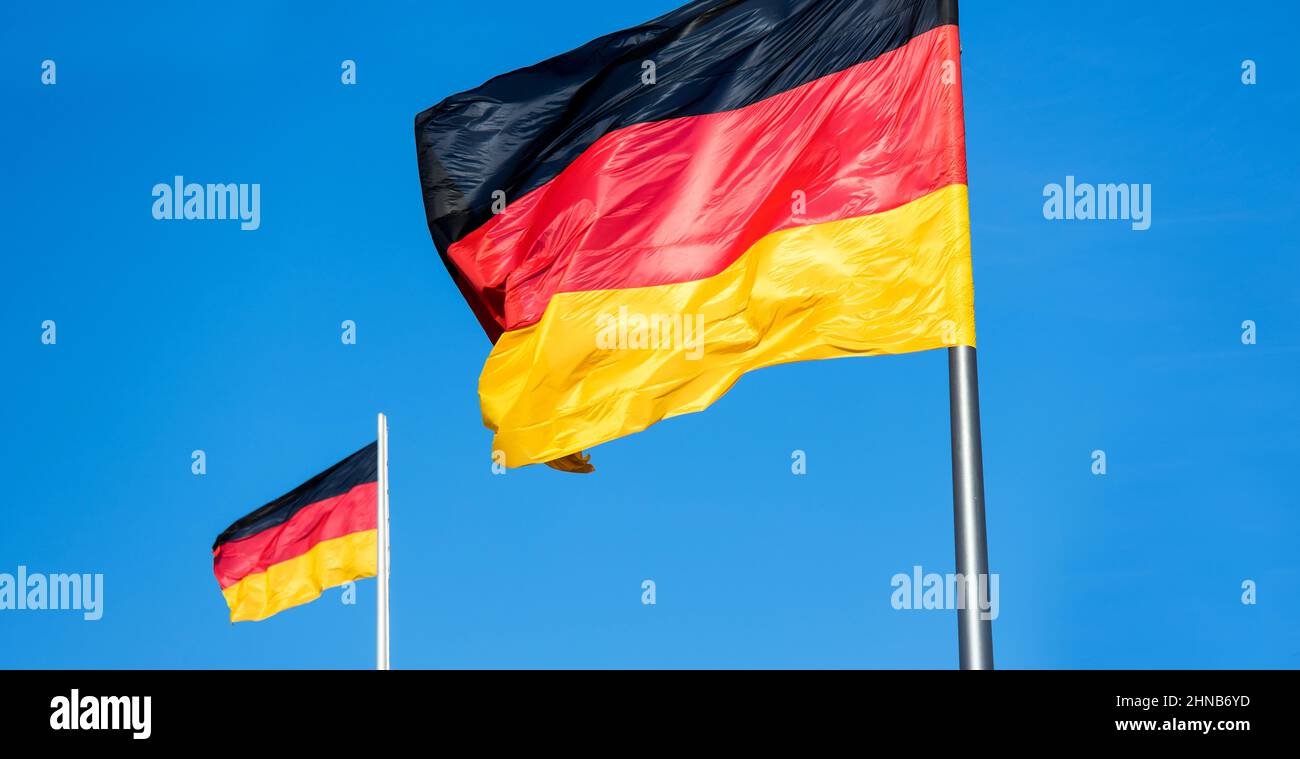 two german flags in strong wind panorama Stock Photo Alamy