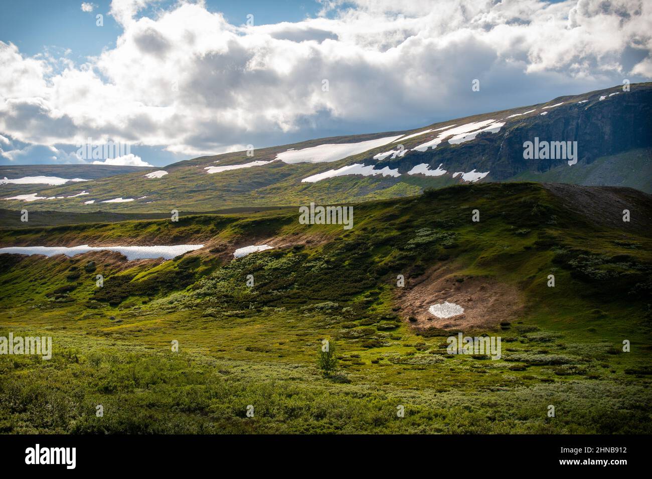 Snow melting along Kungsleden trail between Saltoluokta and Sitojaure in late July, Lapland, Sweden Stock Photo