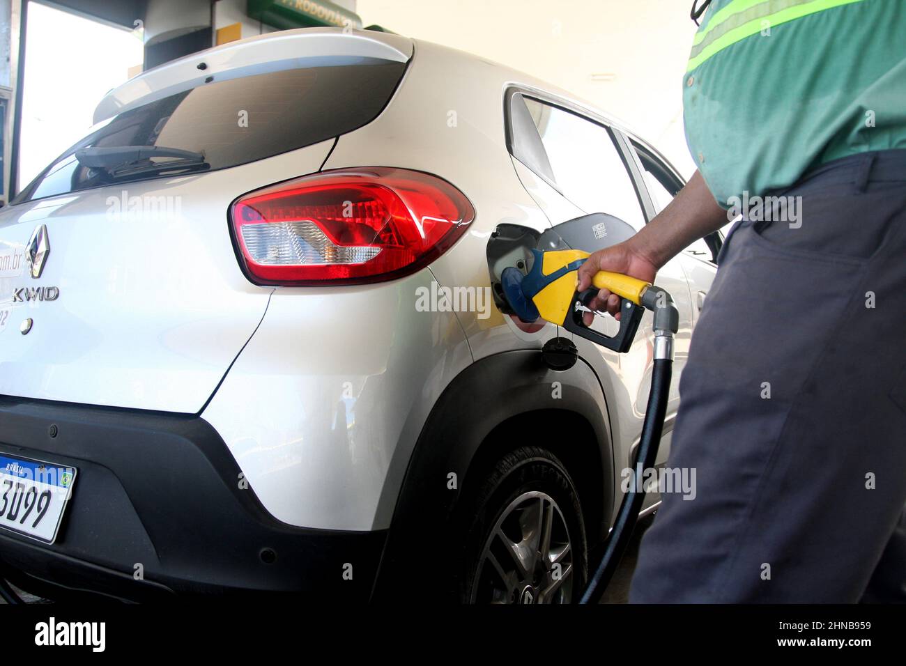 salvador, bahia, brazil - february 7, 2022: gas station attendant fills up gasoline in a vehicle tank at a gas station in the city of Salvador. Stock Photo