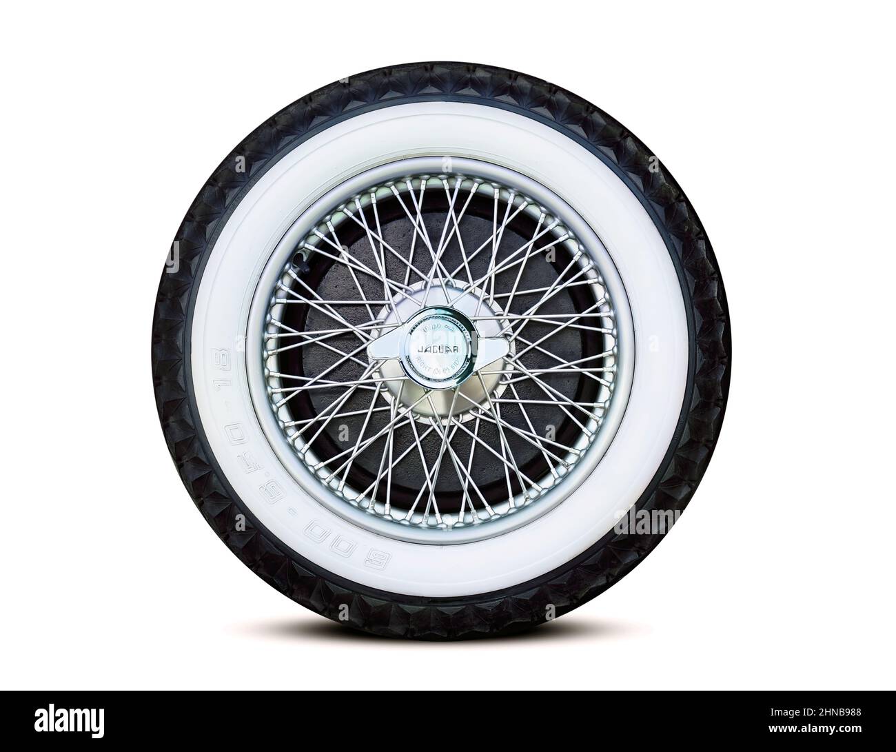 Antique jaguar chrome spoke wheel with emblematic center nut detail Stock Photo