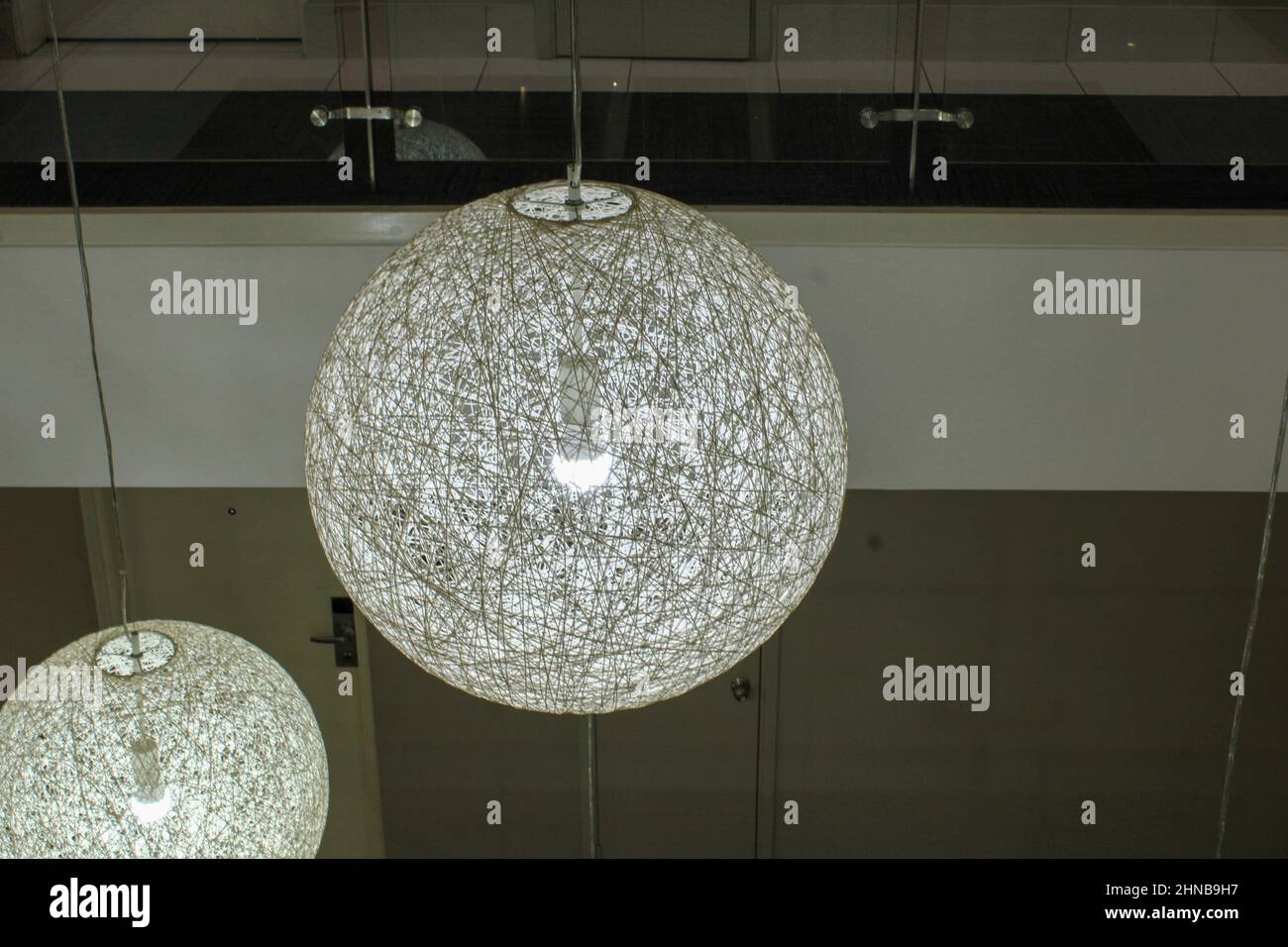 Circular light fixtures in a hotel lobby in Port Moresby, Papua New Guinea. Stock Photo