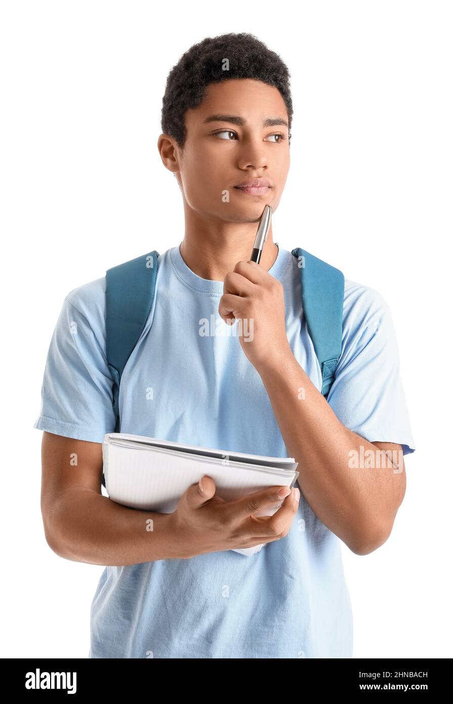 Pensive male African-American student with notebook and pen on white background Stock Photo