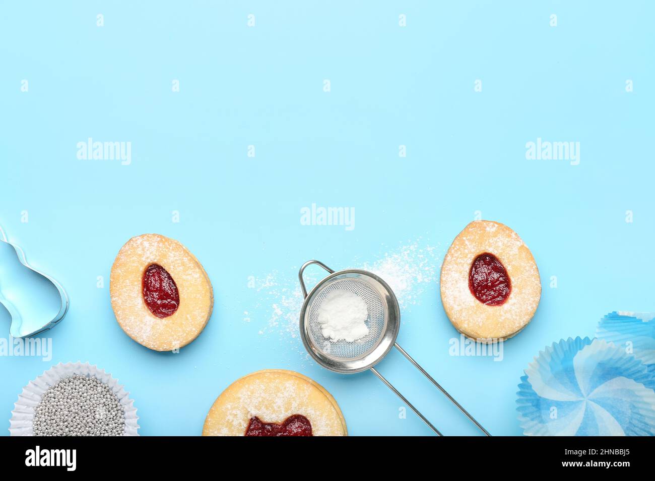 Delicious Easter cookies and utensils on blue background Stock Photo