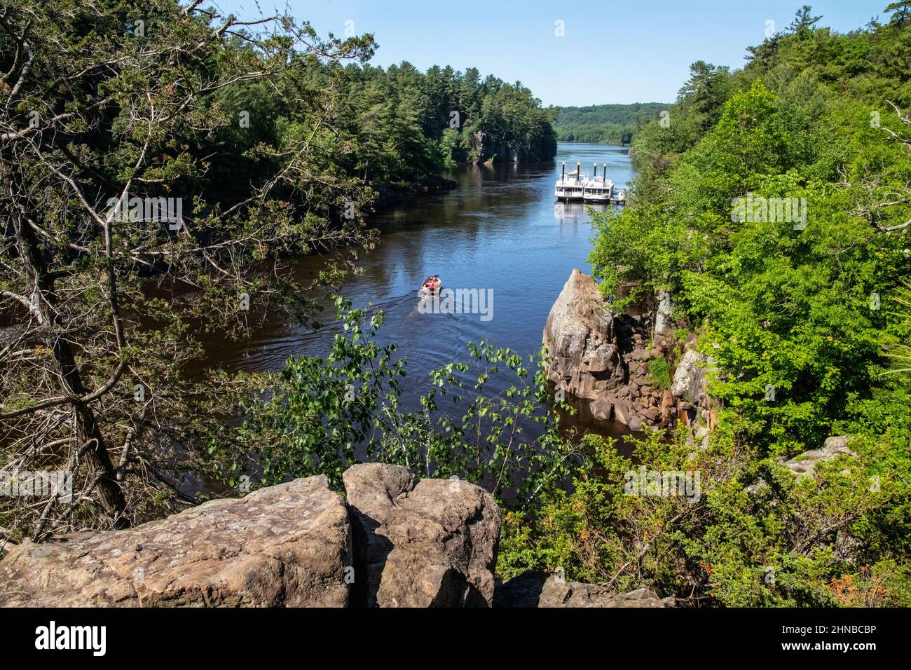 Fishing boat cruising up the St Croix River and the Taylors Falls Queen