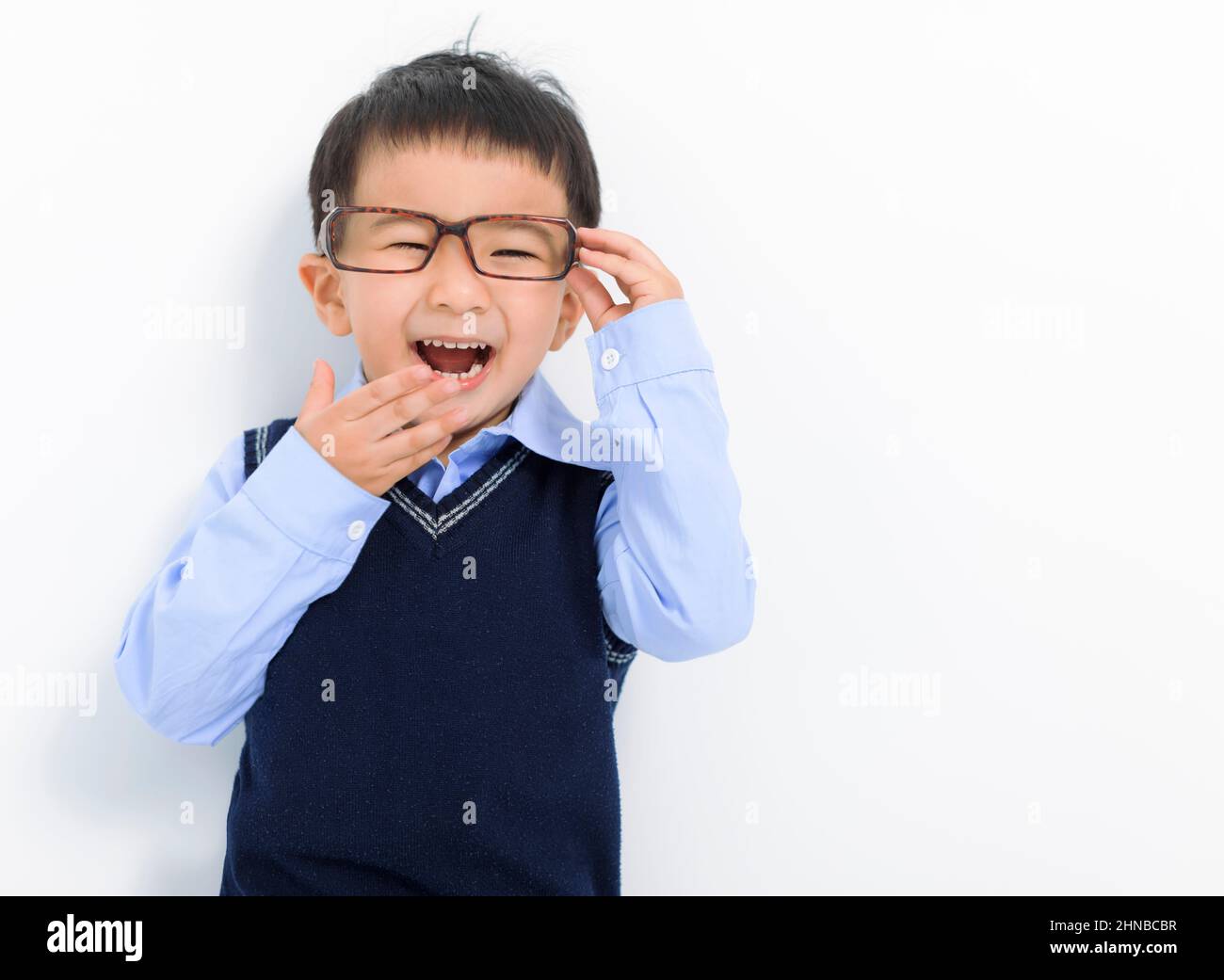 Happy Kid boy holding glasses and having fun Stock Photo