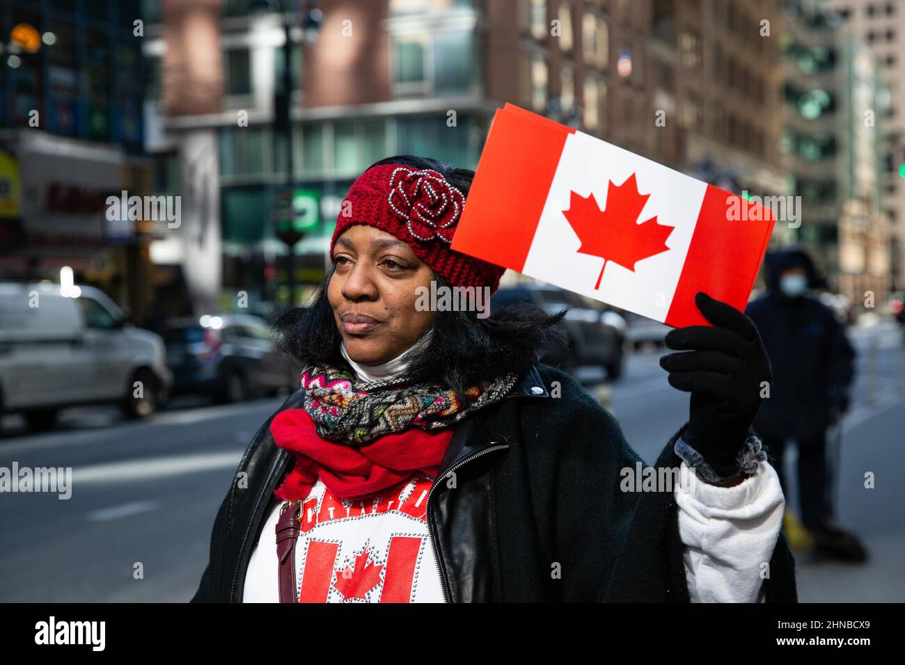 New York, United States. 15th Feb, 2022. Protester holds a Canadian flag during the demonstration.Demonstrators gathered at the Canadian Embassy to stand in solidarity with the Canadian truck blockade in Ottawa. Credit: SOPA Images Limited/Alamy Live News Stock Photo