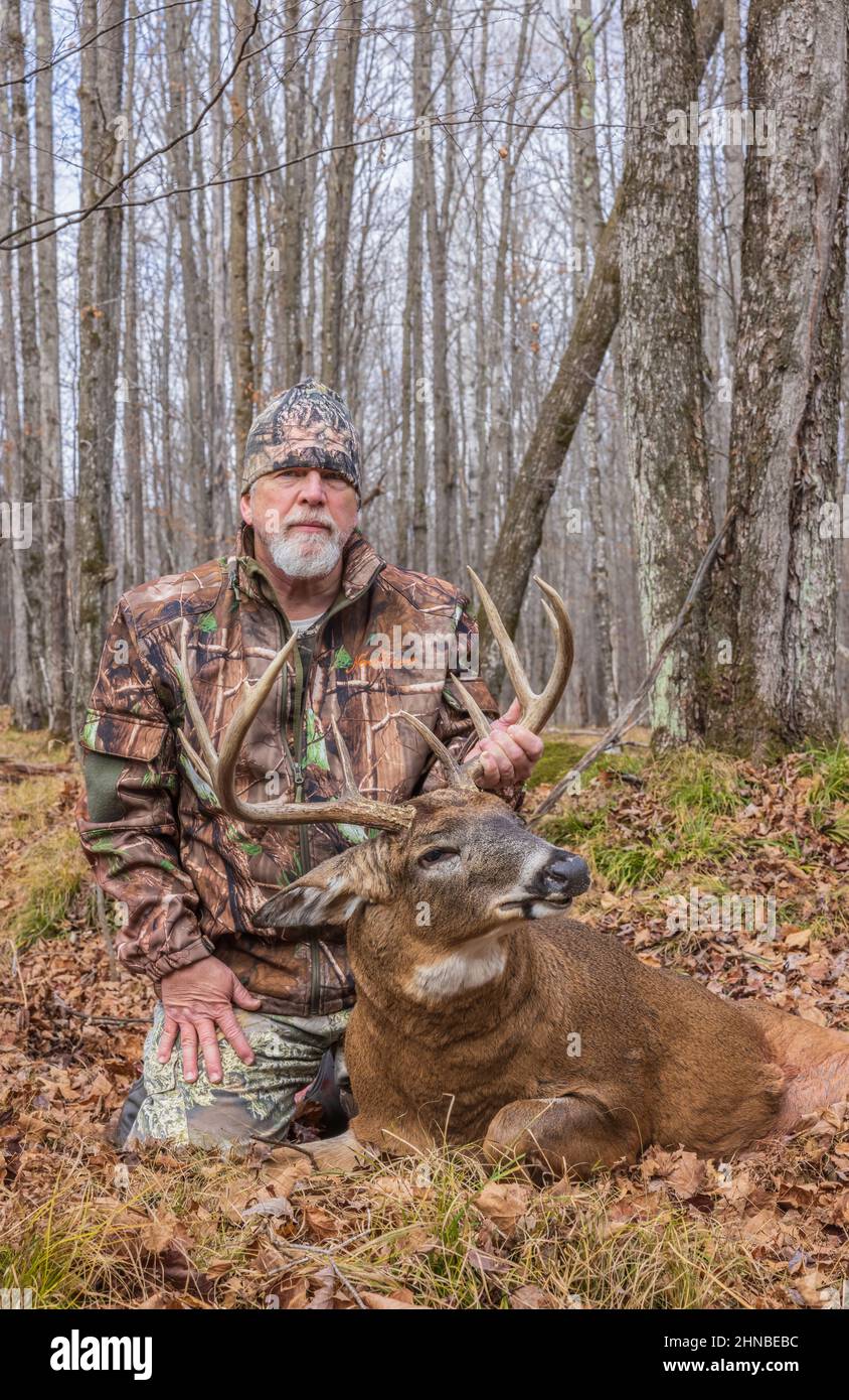 Hunter with a trophy buck shot during the bow season in northern