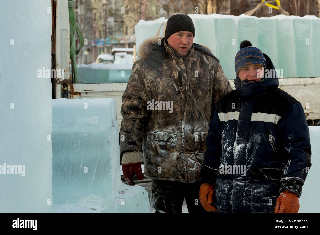 Installers at the ice figure at the construction site are having a conversation Stock Photo