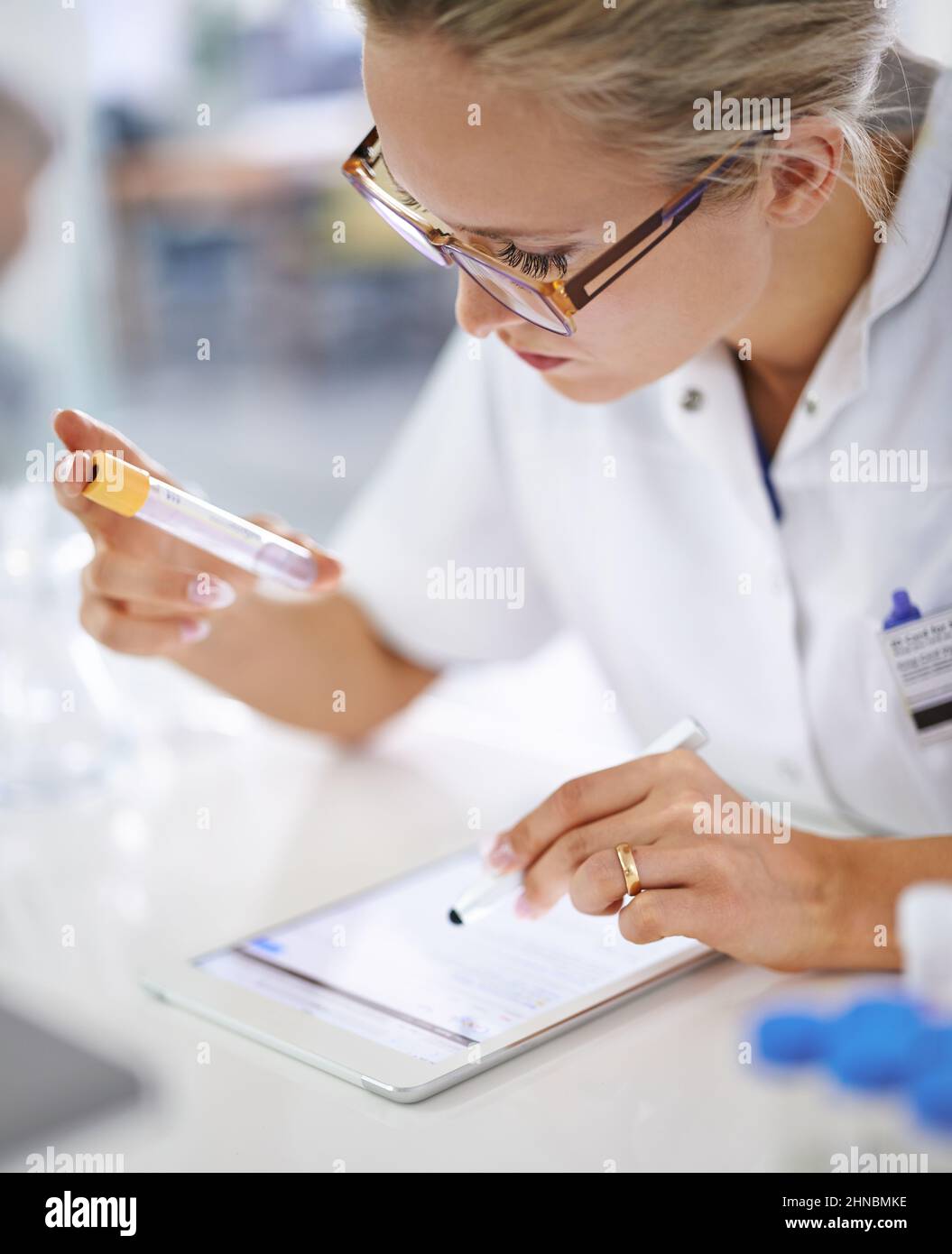 Research and development. A young scientist recording her findings on a tablet. Stock Photo