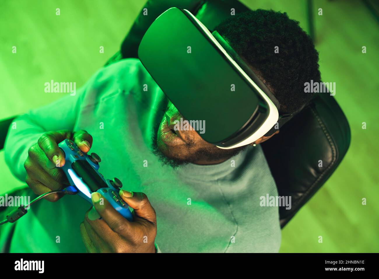 Focussed black man playing on VR game pad - portrait. High quality photo Stock Photo