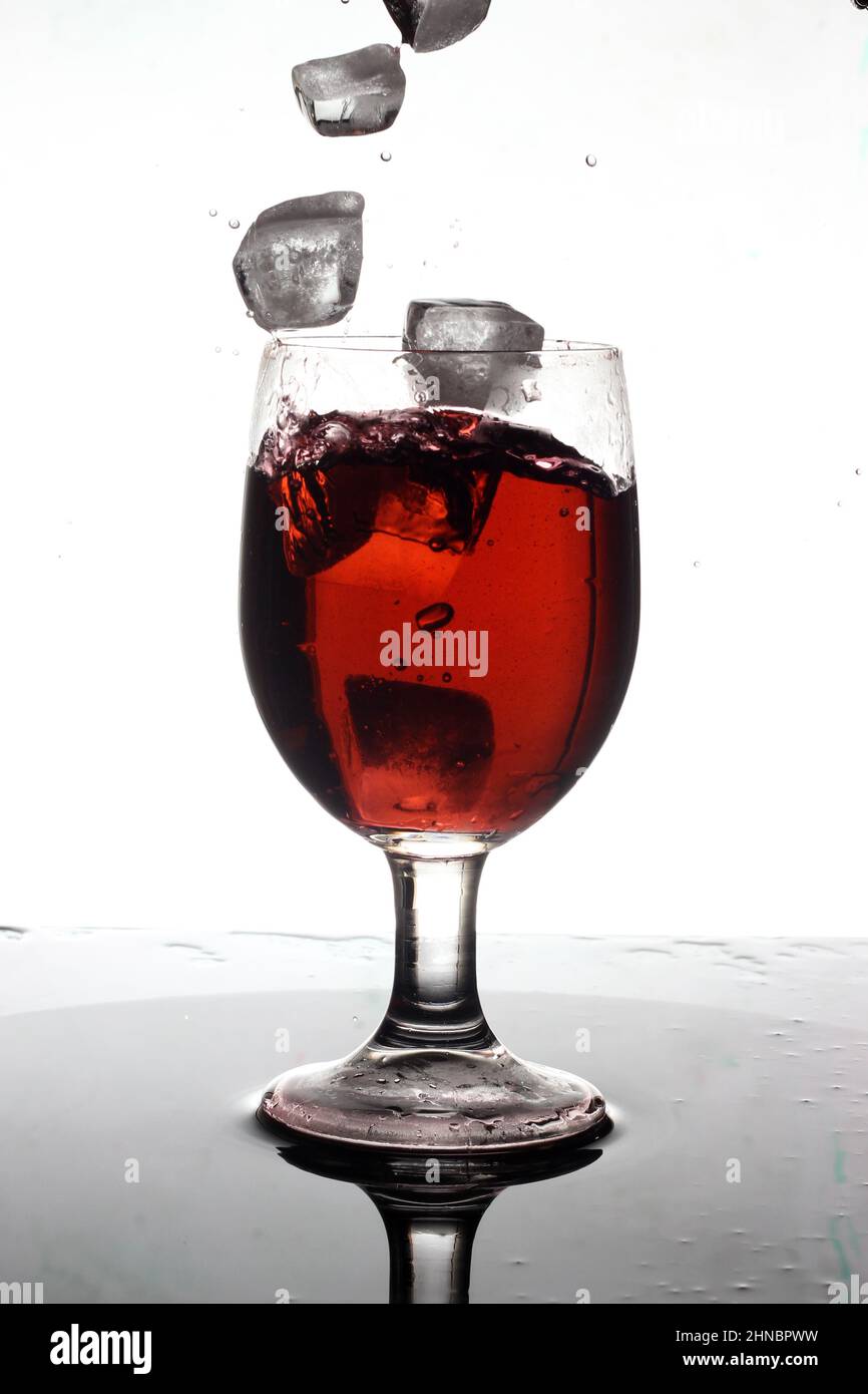 Ice cubes splash into the wine Stock Photo Alamy