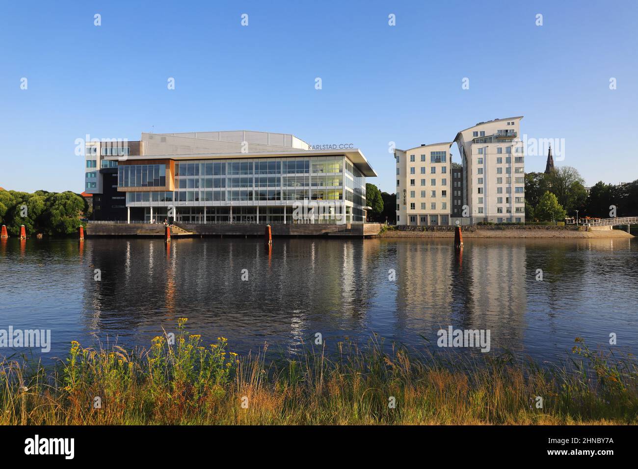 Karlstad, Sweden - July 16, 2021: Two canoeists on the Klaralven river in front of Karlstad CCC, conference, culture and congress center in Karlstad. Stock Photo