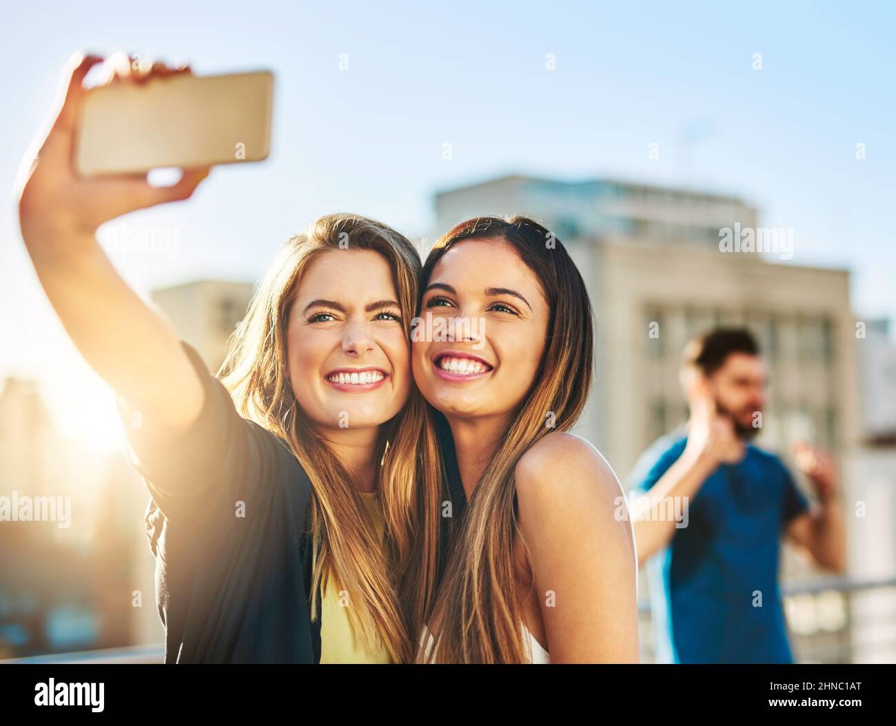Say cheese. Shot of young female friends taking a selfie outside. Stock Photo