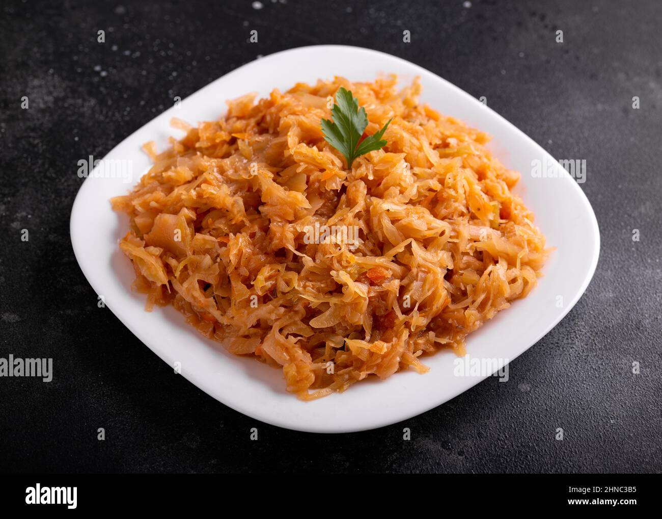 Traditional Homemade Stewed cabbage on white plate Stock Photo