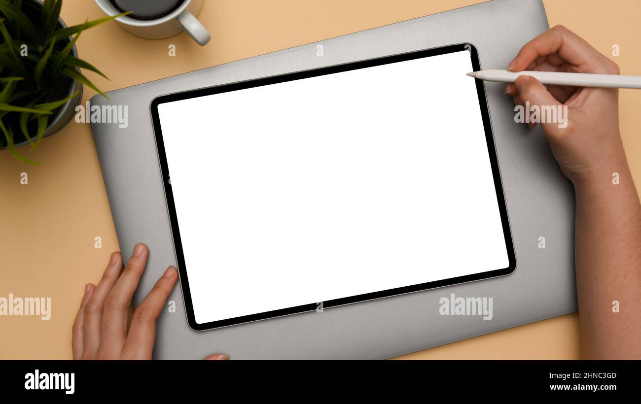 A female hands using a stylus pen draw on digital tablet touchpad