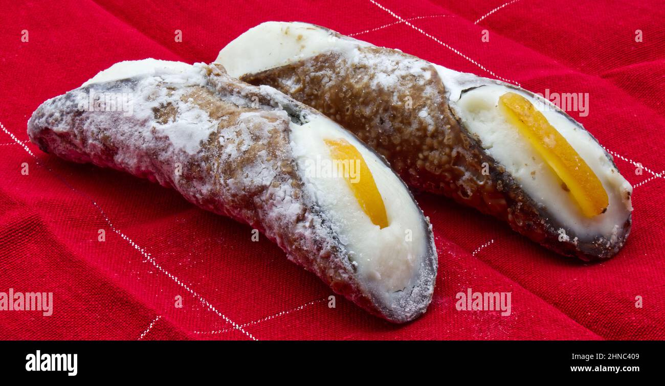 Sweet Cannolo Siciliano. Traditional south Italian dessert. Delicious Sicilian Cannolo filled with ricotta cheese. Stock Photo