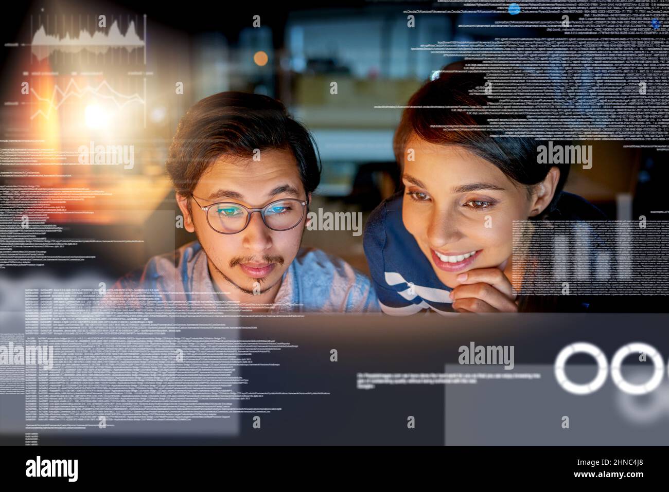 We cracking the code. Shot of computer programmers looking through data in the office. Stock Photo