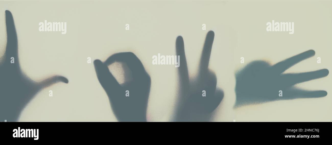 One word that makes the world go round. Shot of a group of unidentifiable people spelling the word love with their hands. Stock Photo