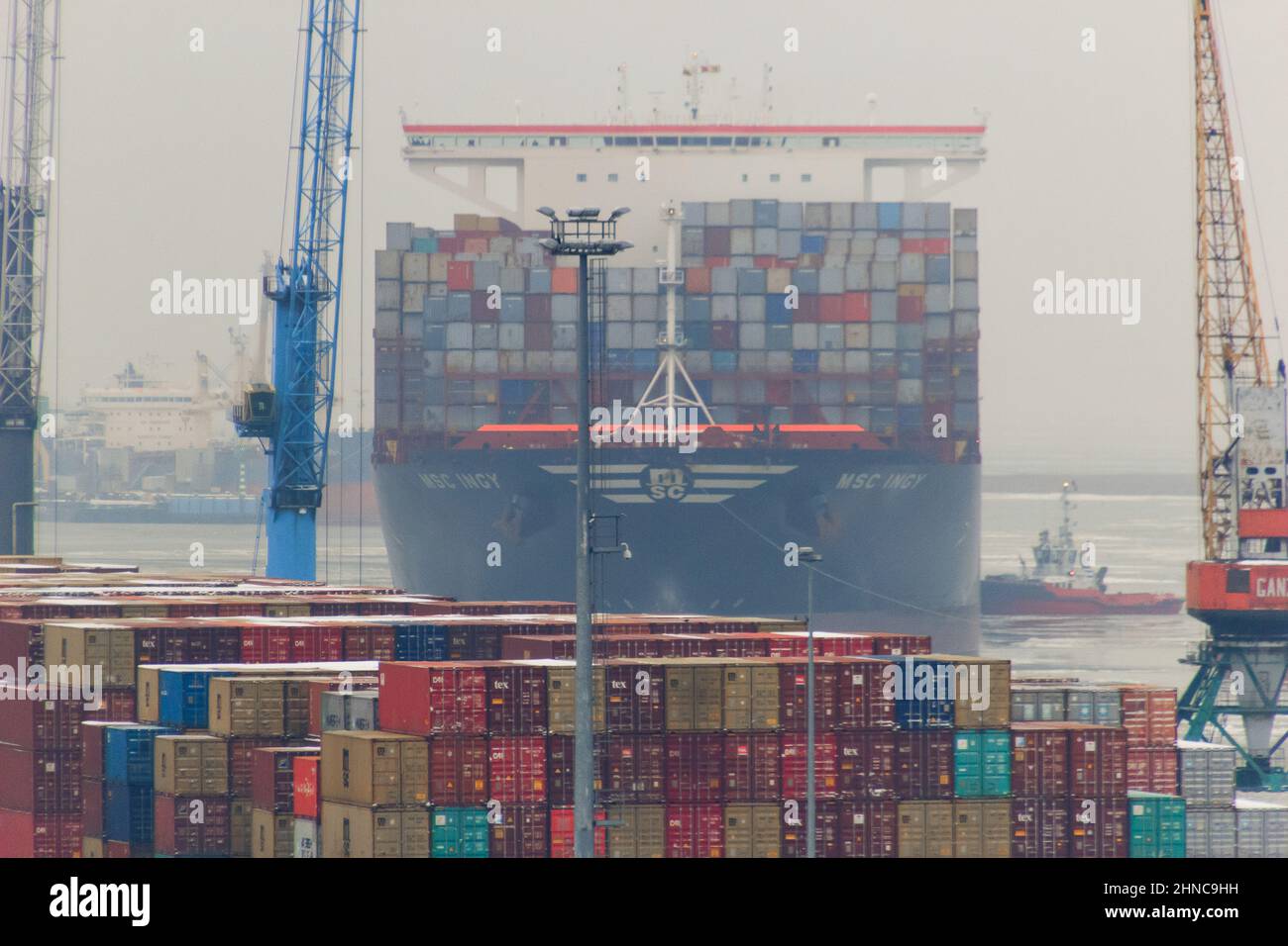 Closeup of a container ship proceeding and mooring at container ...