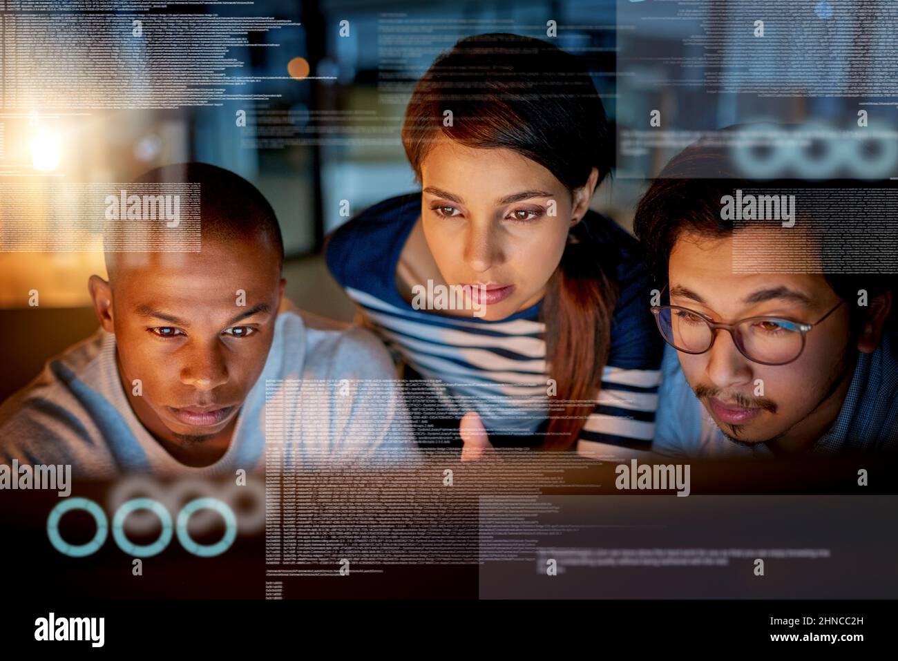 Trying to fix software issues together. Shot of computer programmers looking through data in the office. Stock Photo
