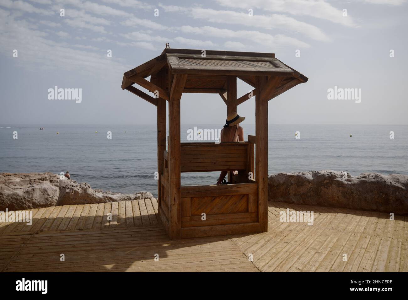 Wooden seat, promenade of Playa del Médano, El Médano, south Tenerife, Canary Islands, Spain, February 2022 Stock Photo