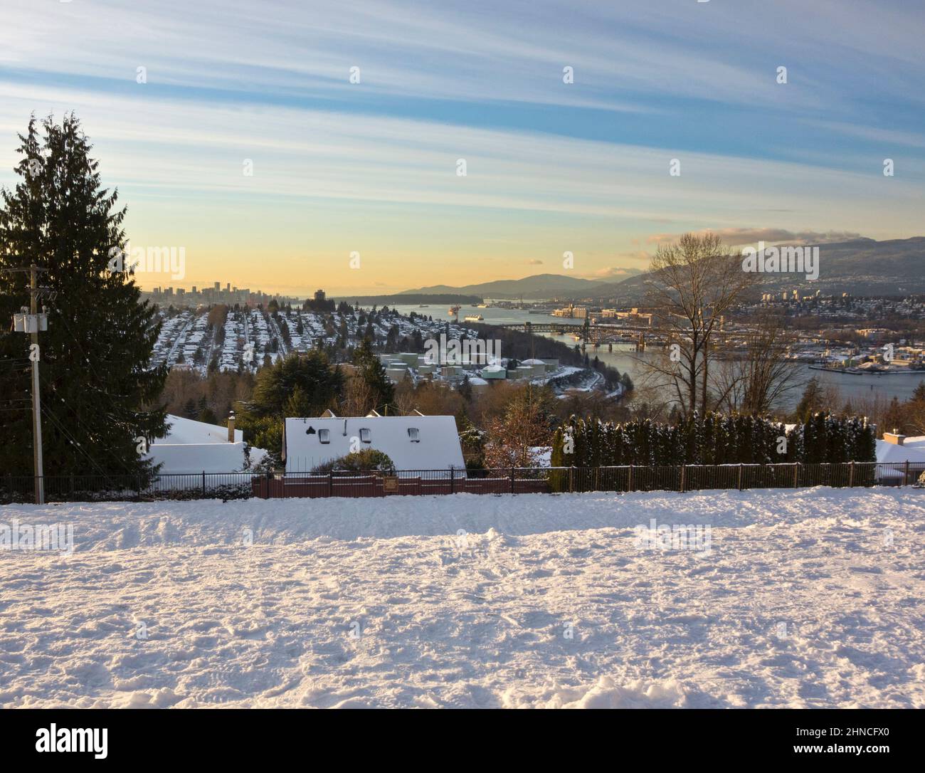 Looking West from Burnaby towards the downtown Vancouver, the Burrard Inlet, and the North Shore mountains on a Winter day with snow. Stock Photo