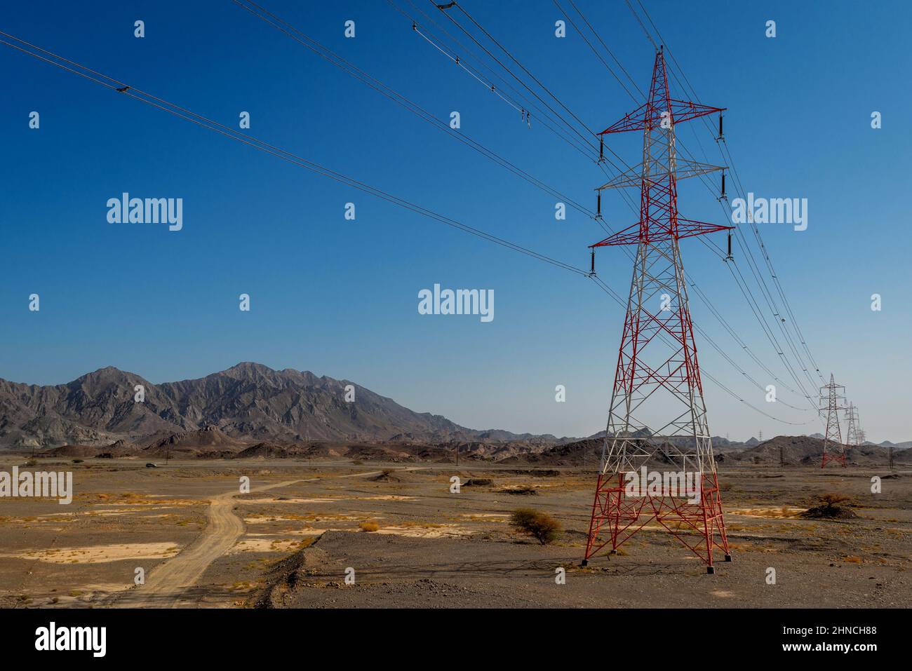 Power poles can also look good, like here in the rocky desert of Oman Stock Photo
