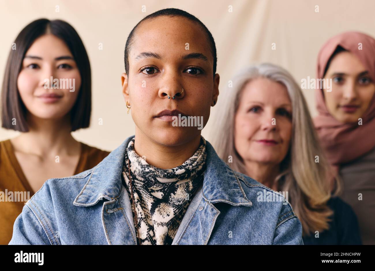 Mid adult multiracial LGBTQ woman in support of International Women's Day with multi ethnic female friends Stock Photo