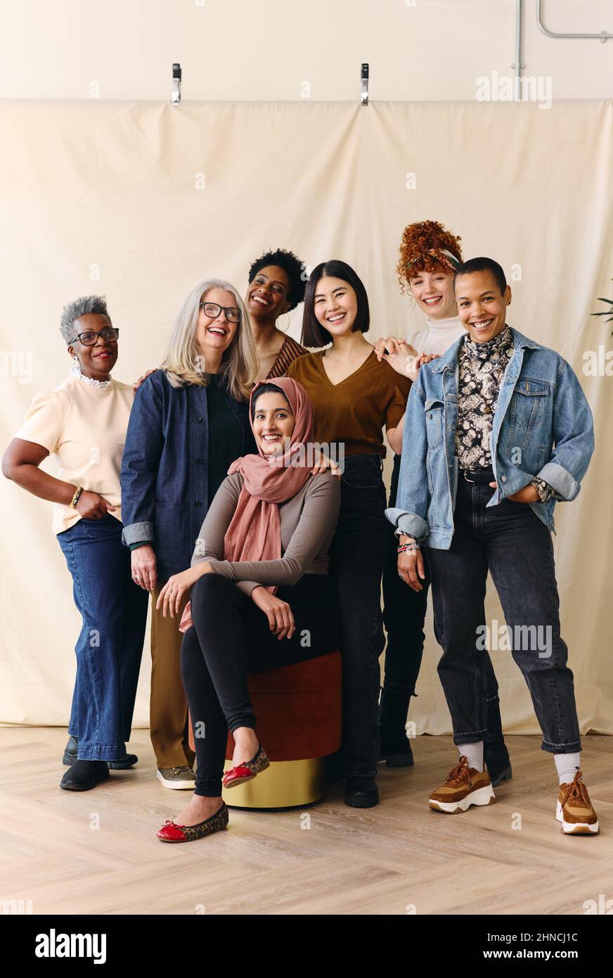 Portrait of mixed age range multi ethnic women smiling in celebration of International Women's Day Stock Photo