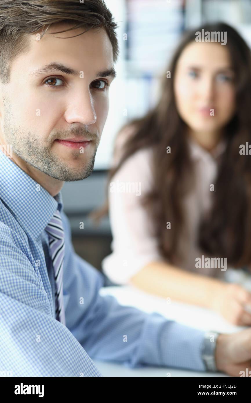 Concentrated business employee at workplace look in camera with female