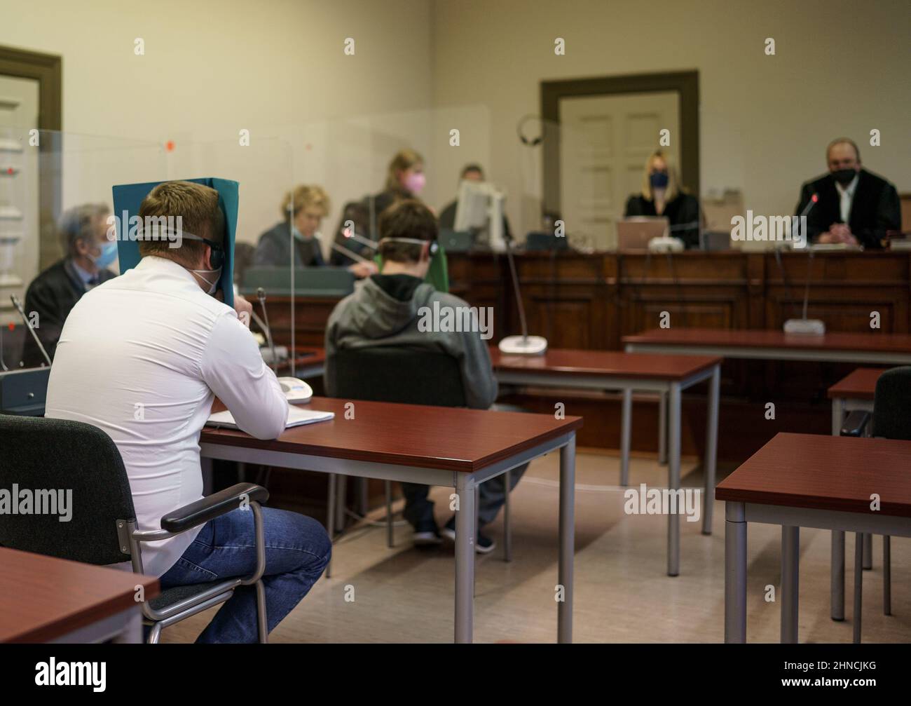 Hamburg, Germany. 16th Feb, 2022. The two 35-year-old defendants (2nd from left and 4th from left) in the trial for attempted murder wait for the trial to begin in a hall at Hamburg Regional Court. The main defendant, together with the alleged accomplice, is alleged to have kicked, beaten and thrown pieces of furniture at the victim in a fitter's apartment in August 2021 in order to act out violent fantasies. Credit: Axel Heimken/dpa/Alamy Live News Stock Photo
