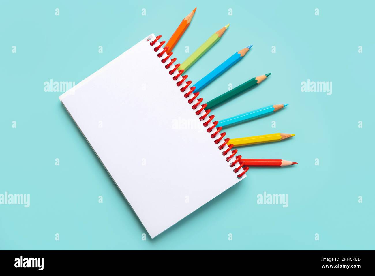 https://c8.alamy.com/comp/2HNCKBD/spiral-notebook-with-colored-pencils-and-with-copy-space-for-your-image-or-text-over-blue-background-2HNCKBD.jpg