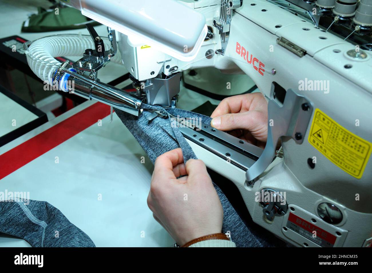 Seamstress hands sew on a pro electrical sewing machine. Parts of