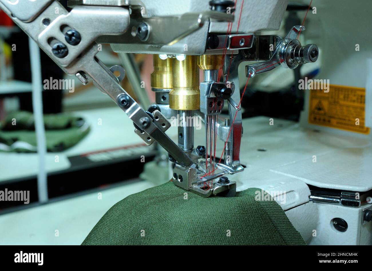 Pro electric sewing machine working. Piece of cloth, needle bar, presser foot, needle plate